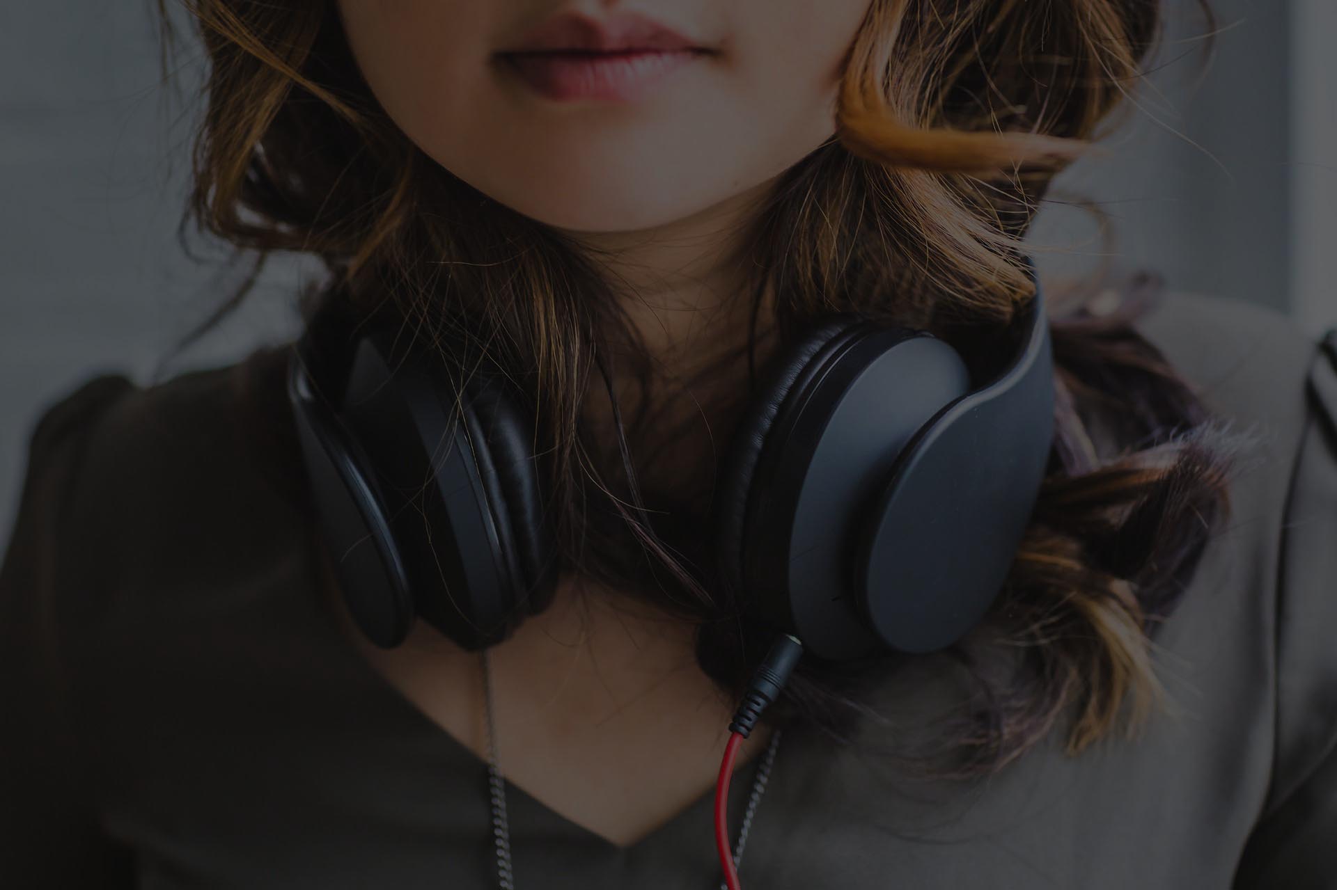 Girl with headphones around neck